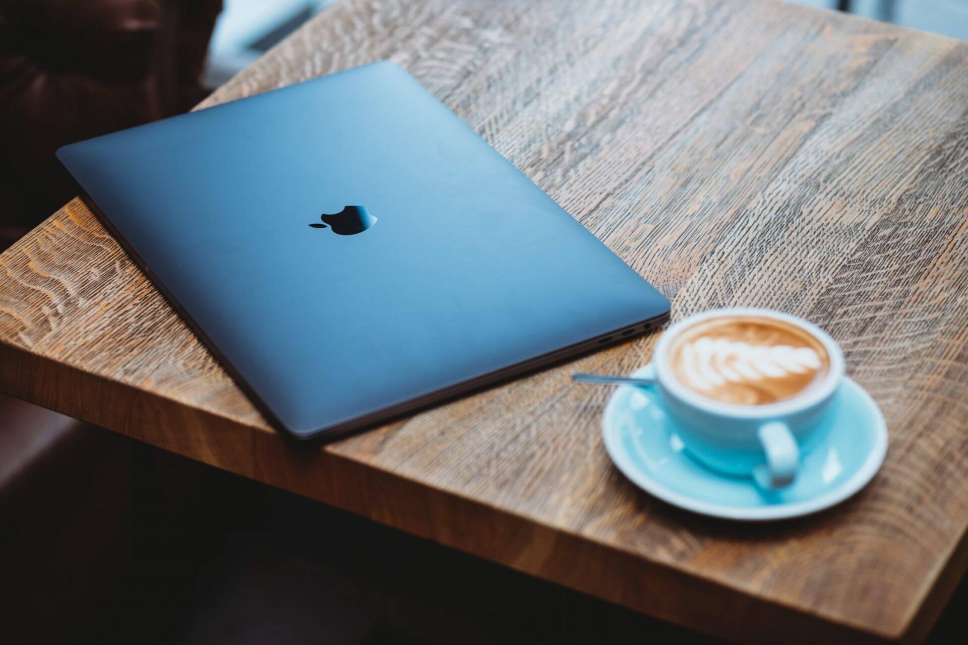macbook pro with coffee on a wooden desk for National SEO