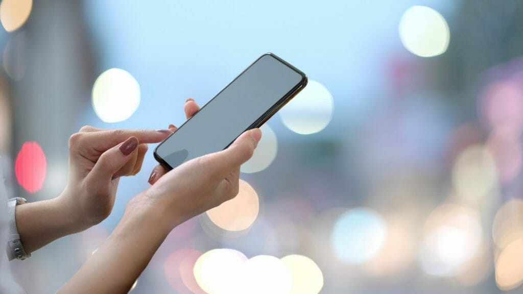 Women scrolling on mobile phone.