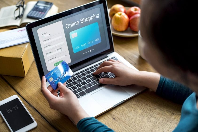 person paying for online shopping with card.